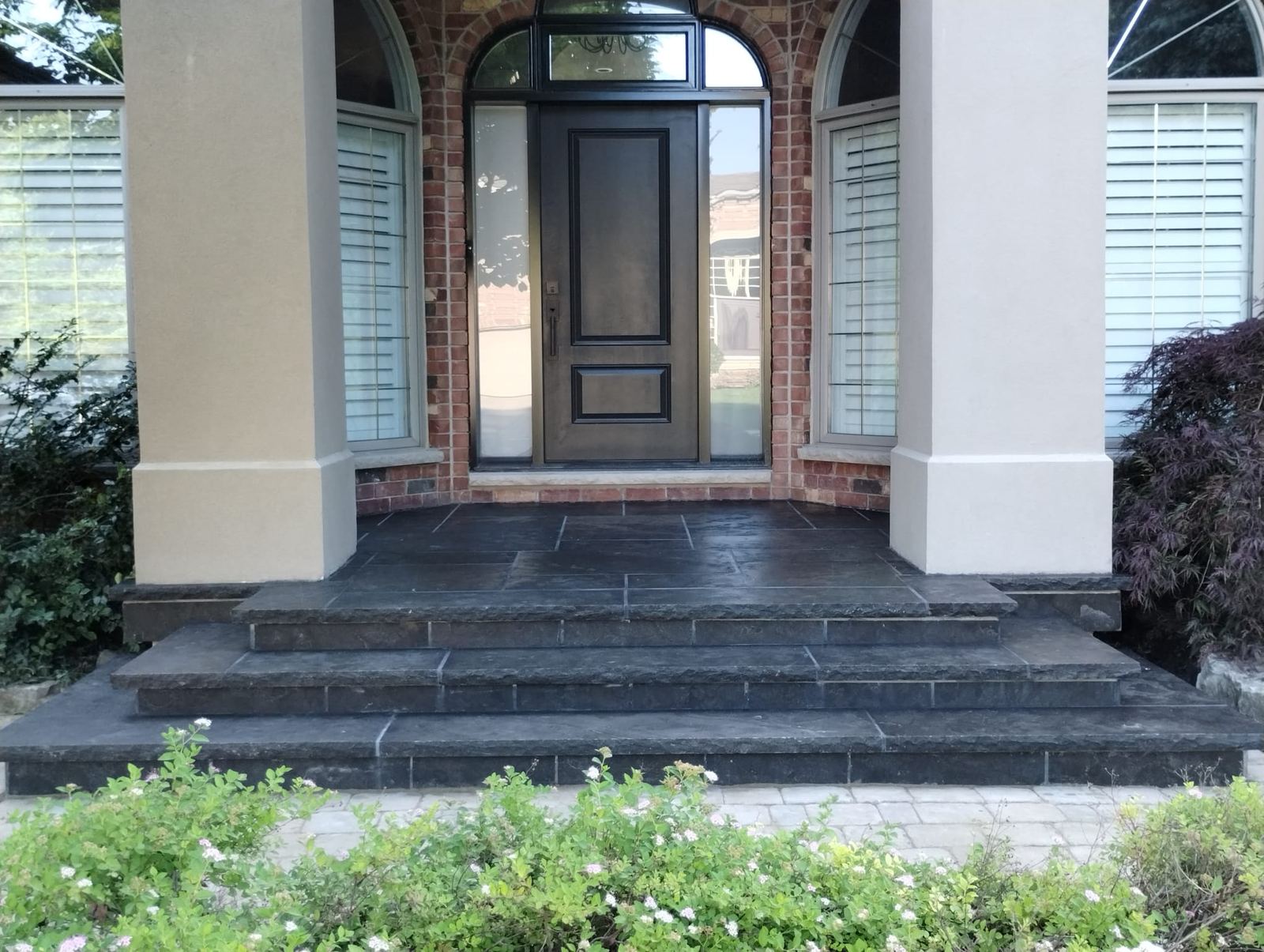 Slate flagstone front entry steps under a brick portico