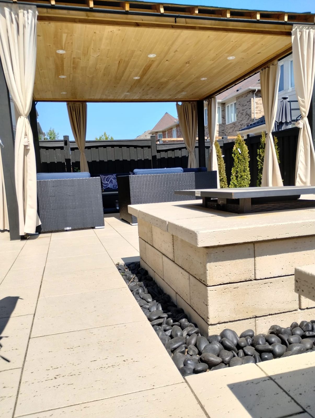 Pergola over a paver patio with a built-in fire feature