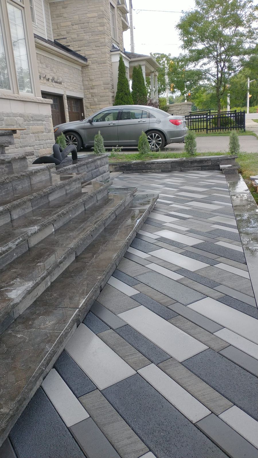 Techo-Bloc paver walkway with natural stone steps at a front entry